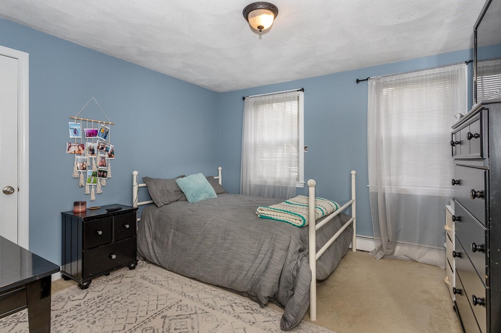 34 Fairview Road Canton, MA 02021 - Photo 12 of 23 a bedroom with a bed and a chandelier