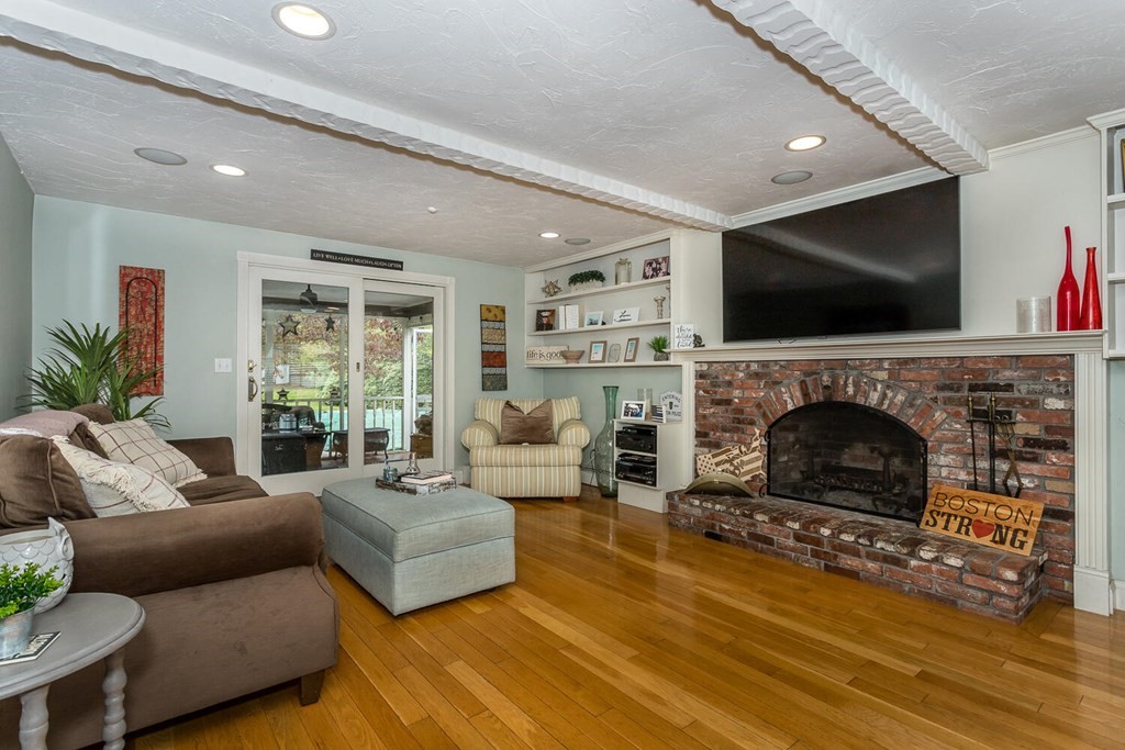 34 Fairview Road Canton, MA 02021 - Photo 4 of 23 a living room with furniture a flat screen tv and a fireplace