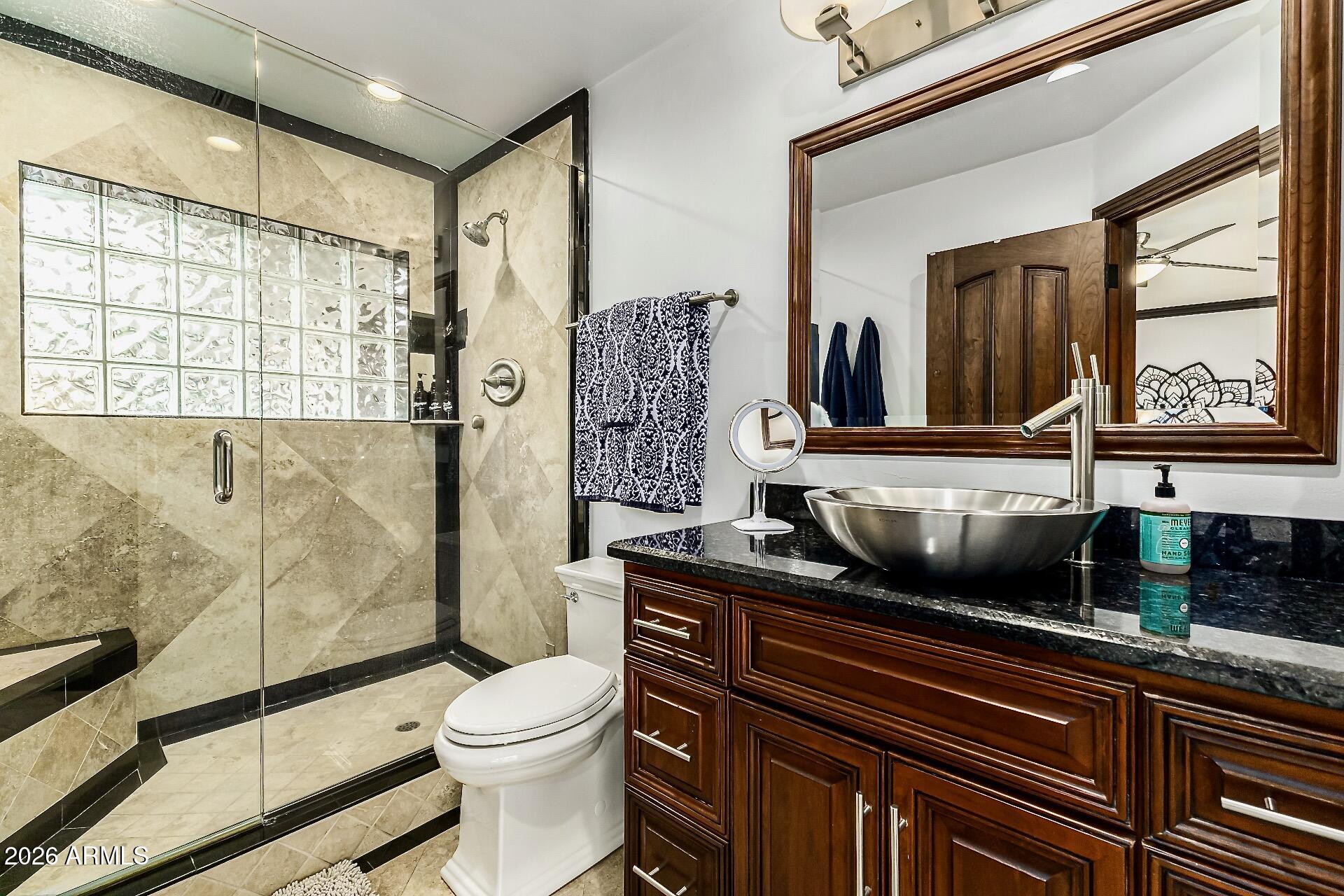 5760 North Scottsdale Road Paradise Valley, AZ 85253 - Photo 11 of 34 a bathroom with a sink a toilet and shower