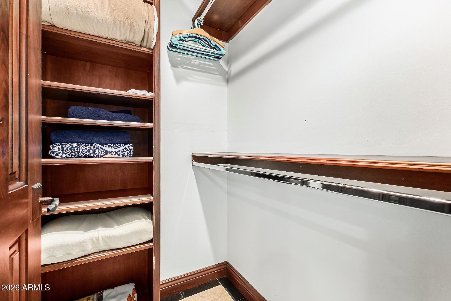 5760 North Scottsdale Road Paradise Valley, AZ 85253 - Photo 12 of 34 a view of walk in closet with clothes and shoes