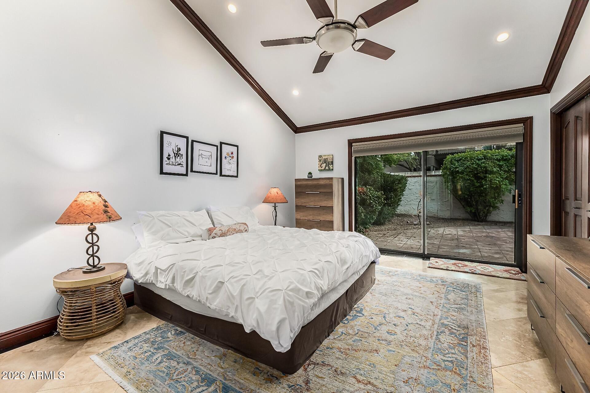 5760 North Scottsdale Road Paradise Valley, AZ 85253 - Photo 13 of 34 a bedroom with a large bed and a chandelier