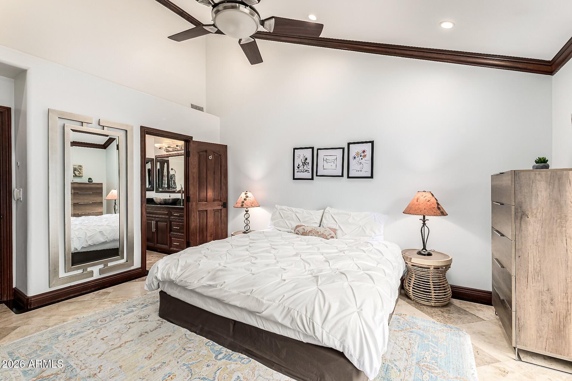 5760 North Scottsdale Road Paradise Valley, AZ 85253 - Photo 14 of 34 a bedroom with a bed and a chandelier