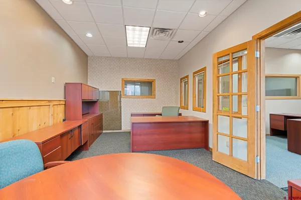 a room with furniture a flat screen tv and a dresser