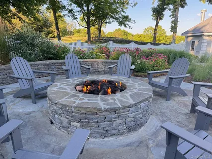 a view of a swimming pool with a patio and a garden
