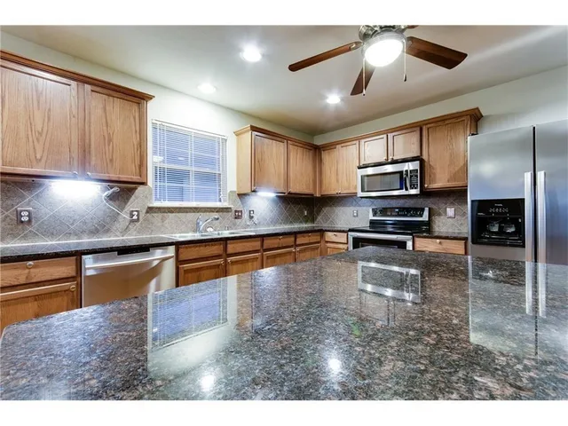 a view of open kitchen with a sink and dishwasher