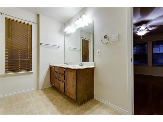 a bathroom with a sink vanity and a mirror