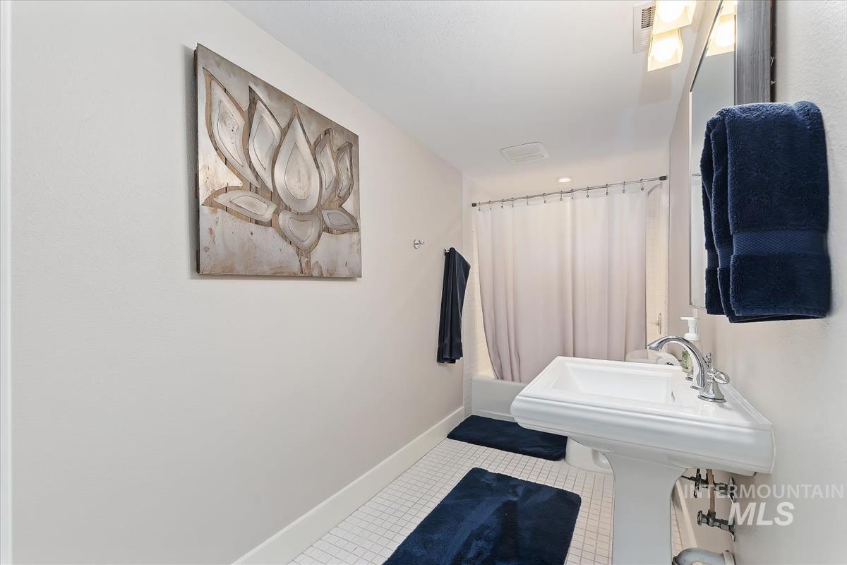 4814 Roberts Road Boise, ID 83705 - Photo 19 of 50 Full bath with shower / bath combination with curtain and tile patterned floors
