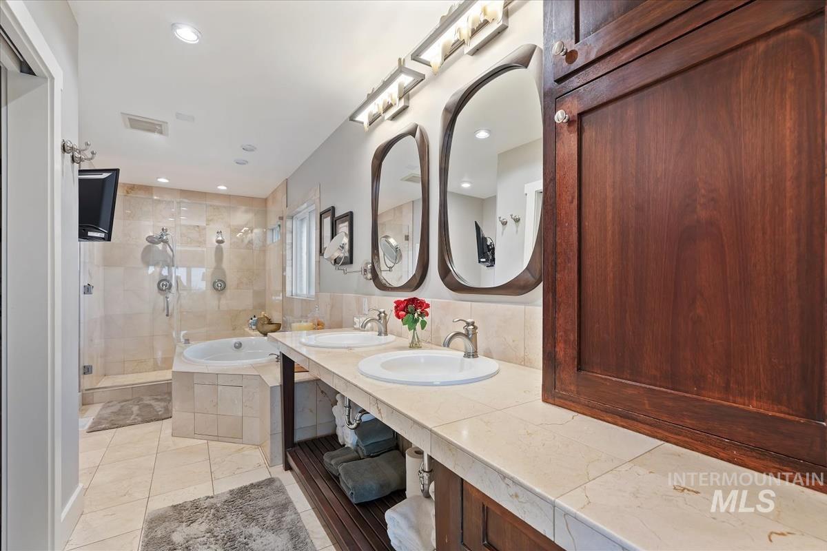 4814 Roberts Road Boise, ID 83705 - Photo 33 of 50 Full bathroom with a garden tub, double vanity, and a shower stall