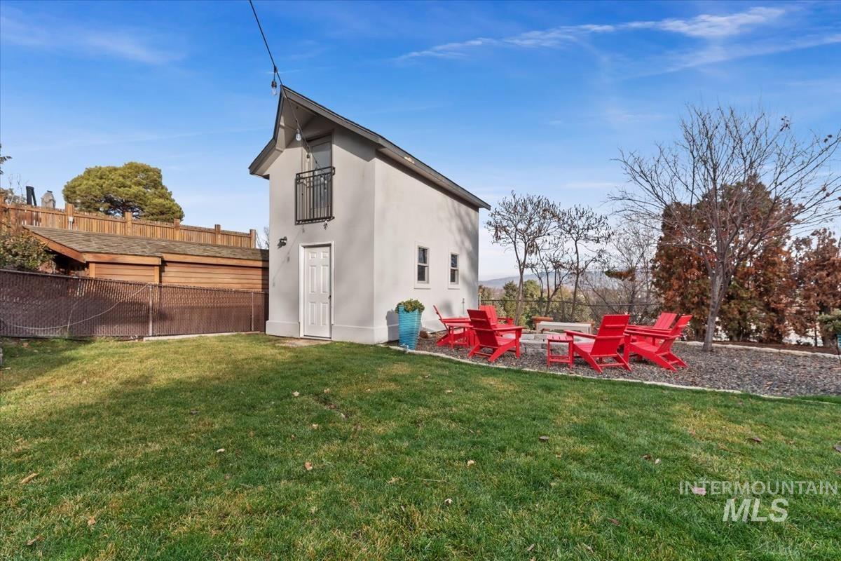 4814 Roberts Road Boise, ID 83705 - Photo 42 of 50 Back of house featuring a fenced backyard, stucco siding, a patio area, and an outdoor fire pit