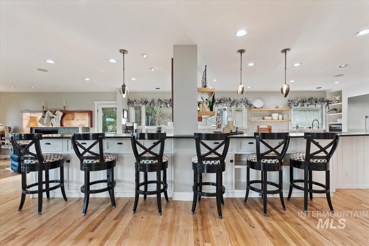 4814 Roberts Road Boise, ID 83705 - Photo 7 of 50 Kitchen featuring open shelves, hanging light fixtures, dark countertops, recessed lighting, and a kitchen bar