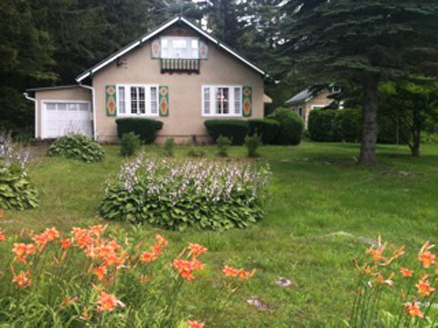 231 Sandisfield Road Sandisfield, MA 01255 - Photo 1 of 12 a front view of a house with a garden