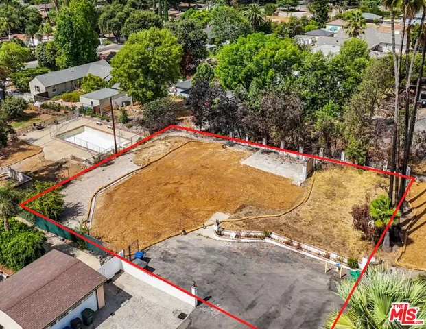an aerial view of a house with outdoor seating