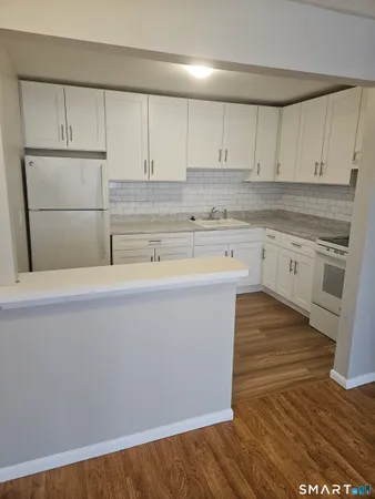 a kitchen with a sink cabinets stainless steel appliances and cabinets