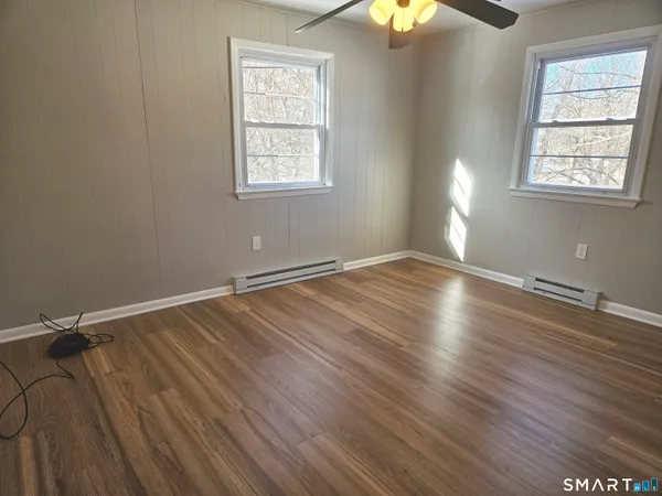 wooden floor in an empty room with a window