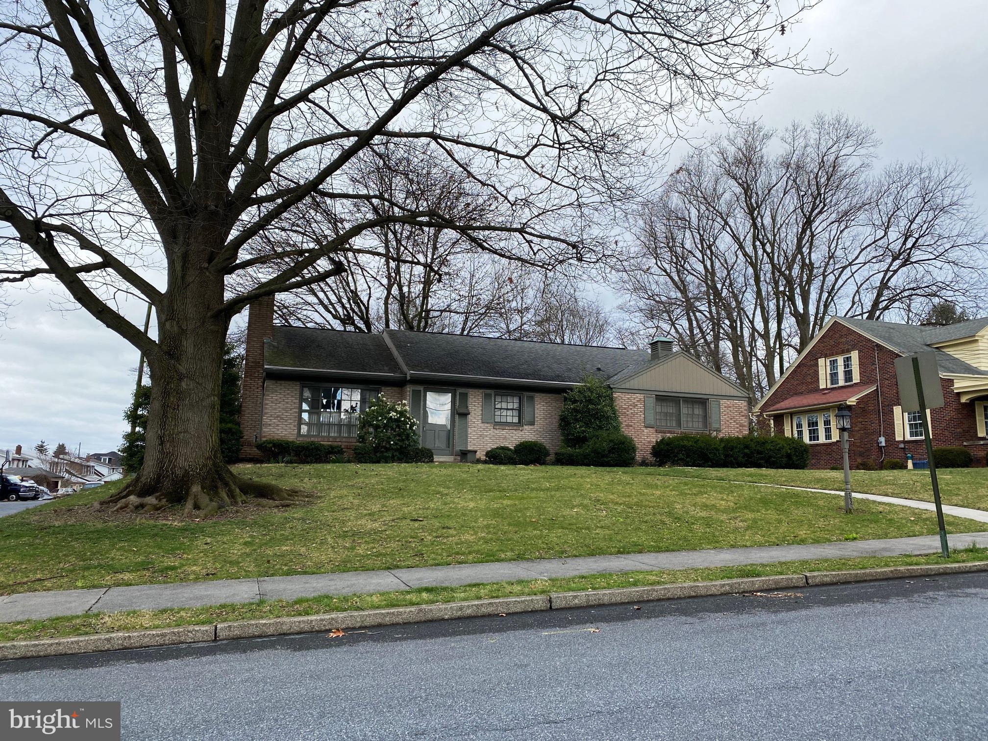 a house that has a tree in front of a house