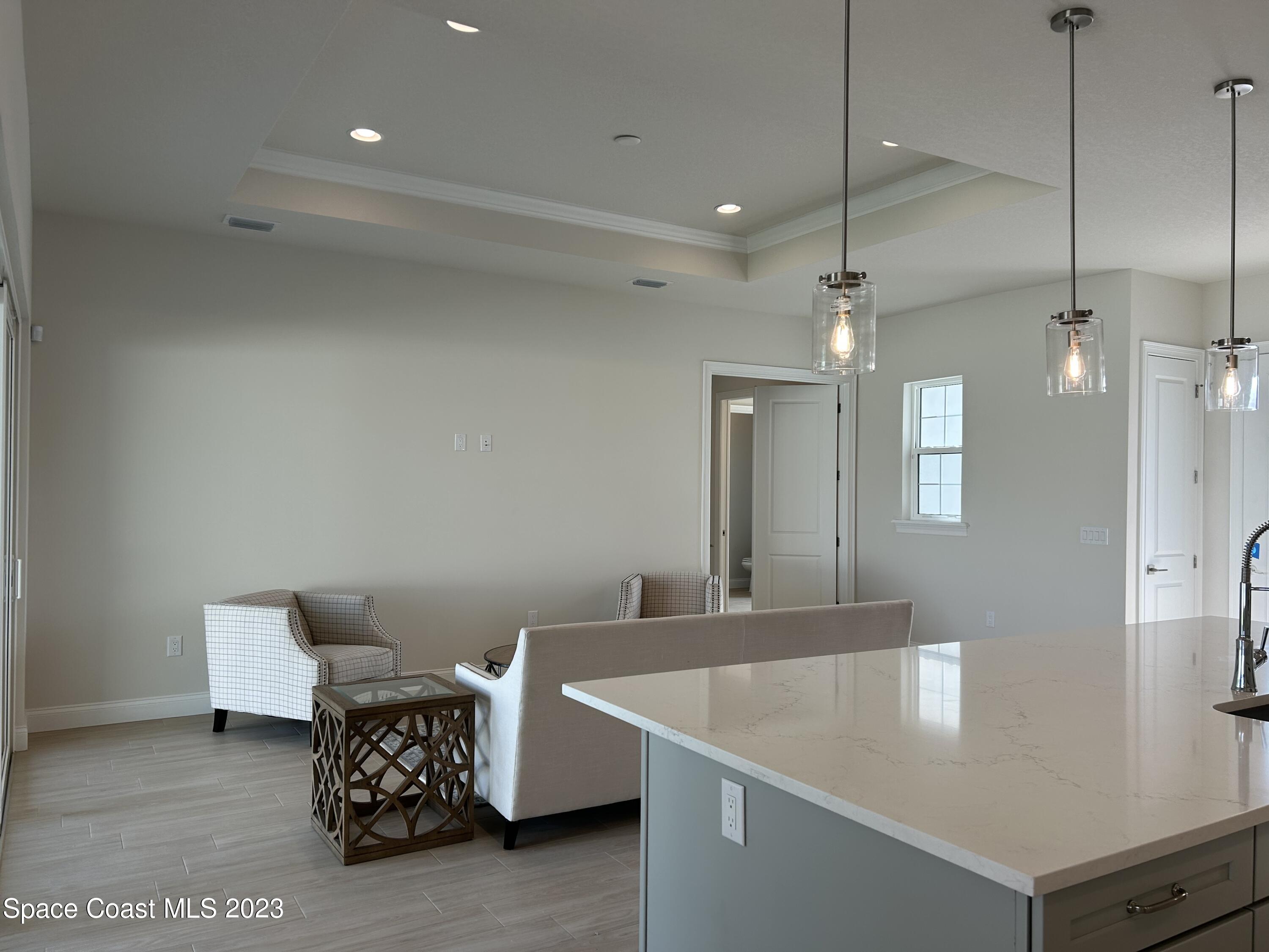 4095 Negal Circle Melbourne, FL 32901 - Photo 11 of 20 a living room with furniture and a chandelier