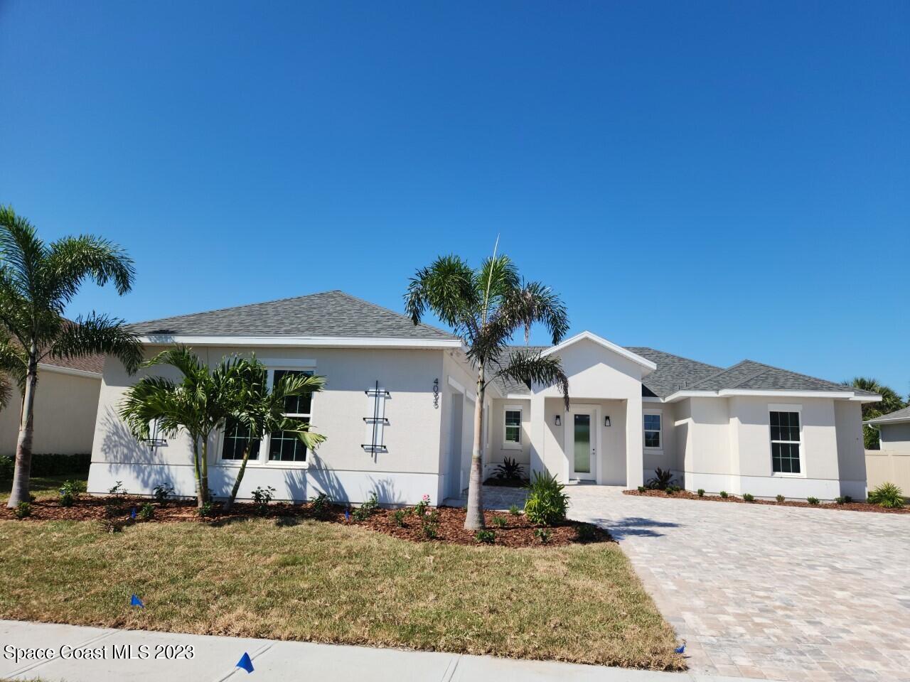 4095 Negal Circle Melbourne, FL 32901 - Photo 2 of 20 a front view of a house with a garden