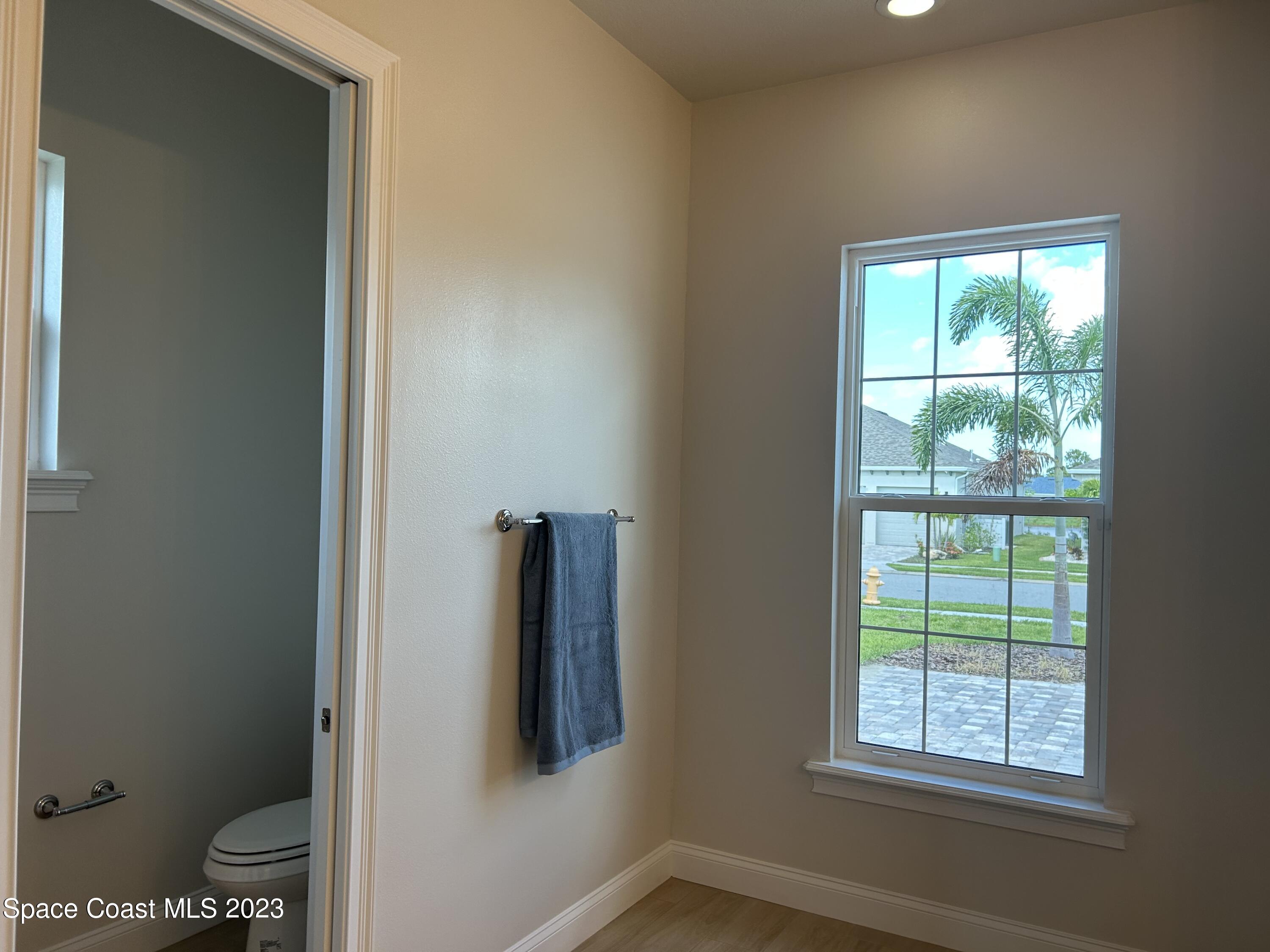 4095 Negal Circle Melbourne, FL 32901 - Photo 6 of 20 a bathroom with a toilet and a window