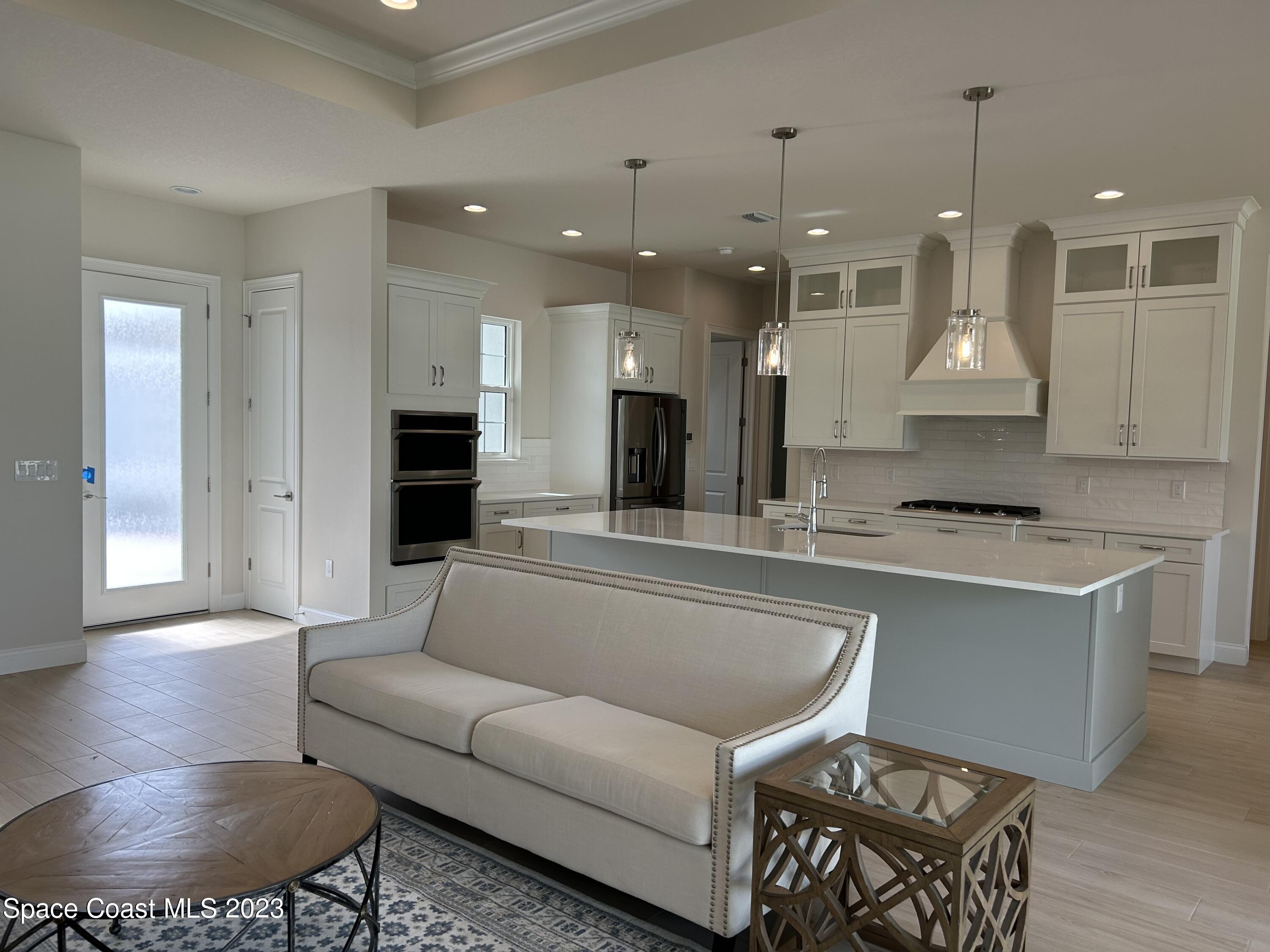 4095 Negal Circle Melbourne, FL 32901 - Photo 8 of 20 a living room with furniture and a wooden floor