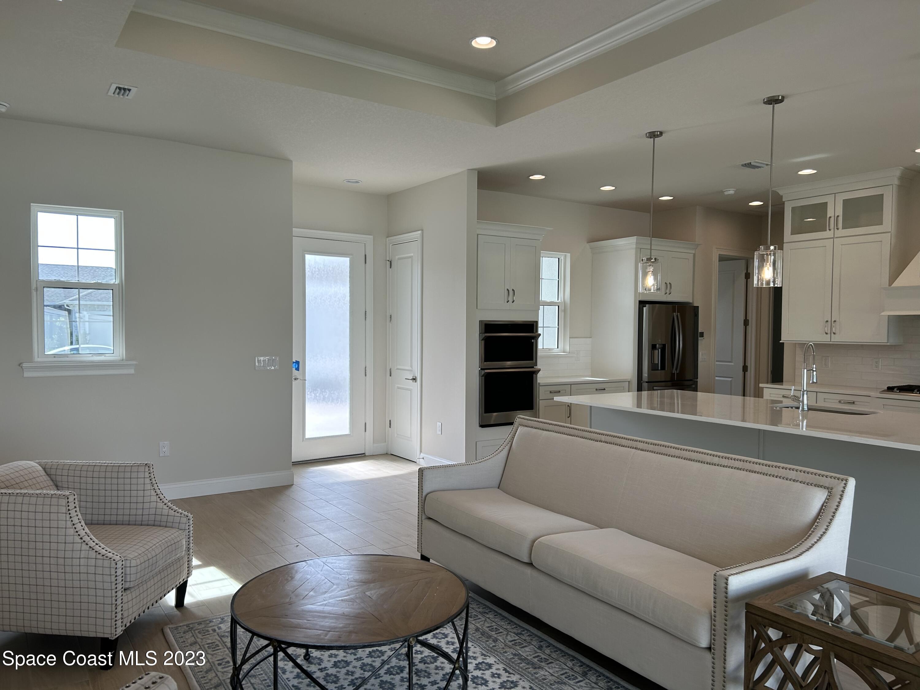 4095 Negal Circle Melbourne, FL 32901 - Photo 9 of 20 a living room with furniture and a view of kitchen