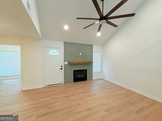a view of a livingroom with a fireplace and a ceiling fan
