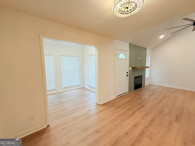 a view of empty room with wooden floor