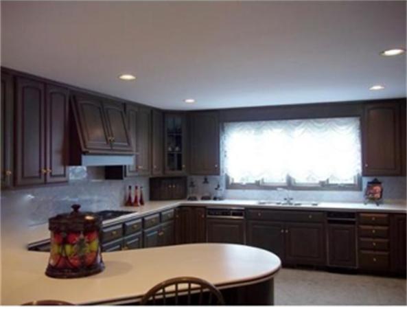 96 Narrows Road Freetown, MA 02702 - Photo 23 of 26 a kitchen with a sink and wooden cabinets