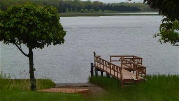 96 Narrows Road Freetown, MA 02702 - Photo 26 of 26 a view of a lake with a bench in the background