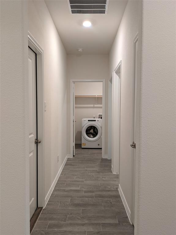 3024 Meredith Lane Forney, TX 75126 - Photo 6 of 22 a view of a hallway with a wooden floor and a washing machine