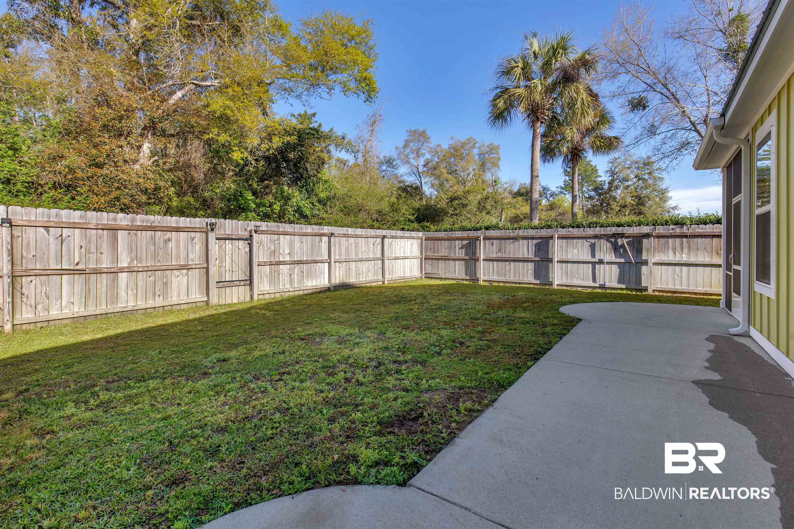 8069 Carmel Circle Foley, AL 36535 - Photo 21 of 23 View of yard featuring a patio and a fenced backyard
