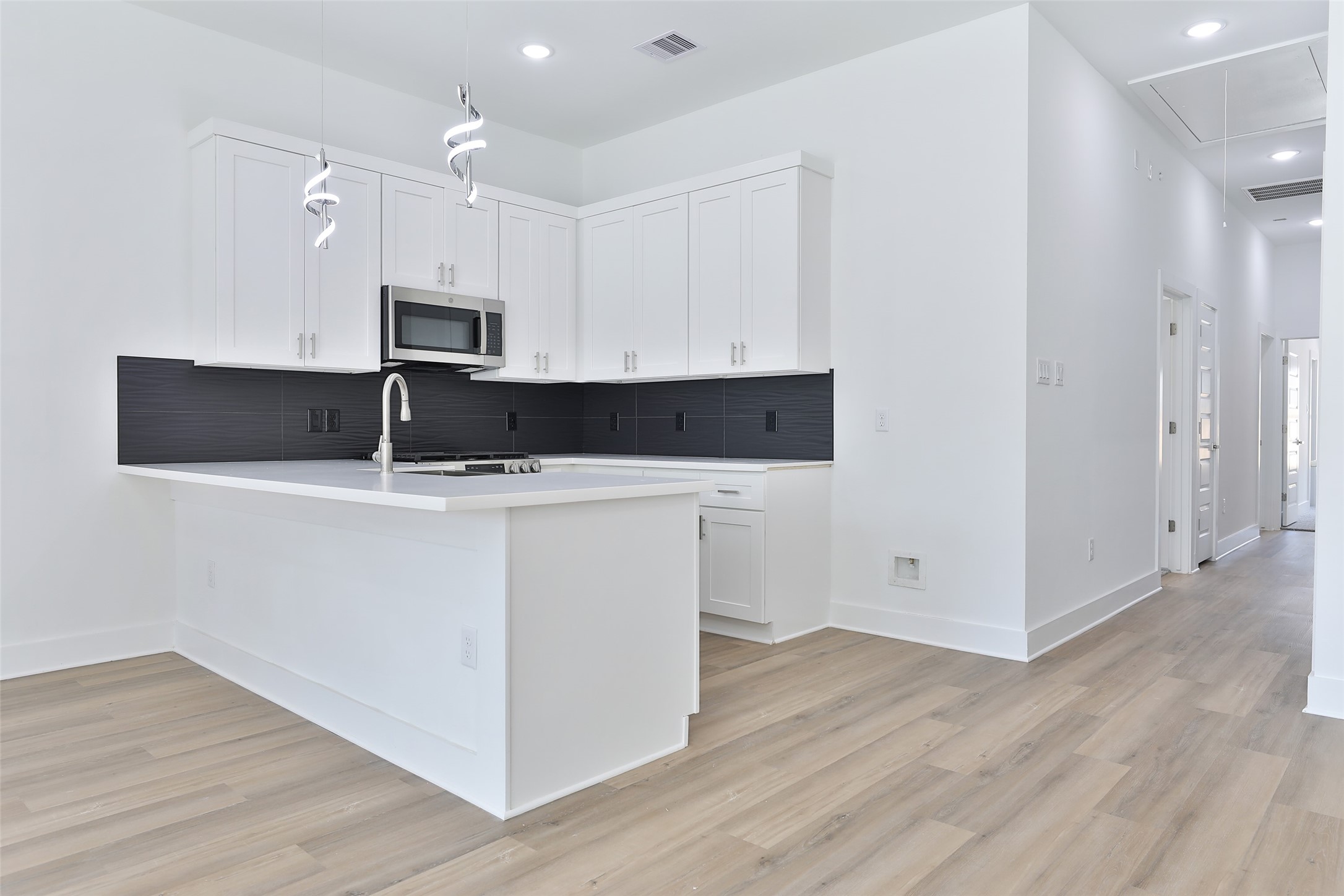 8109 Cabot Street, Unit A/B Houston, TX 77078 - Photo 11 of 33 a kitchen with cabinets and stainless steel appliances