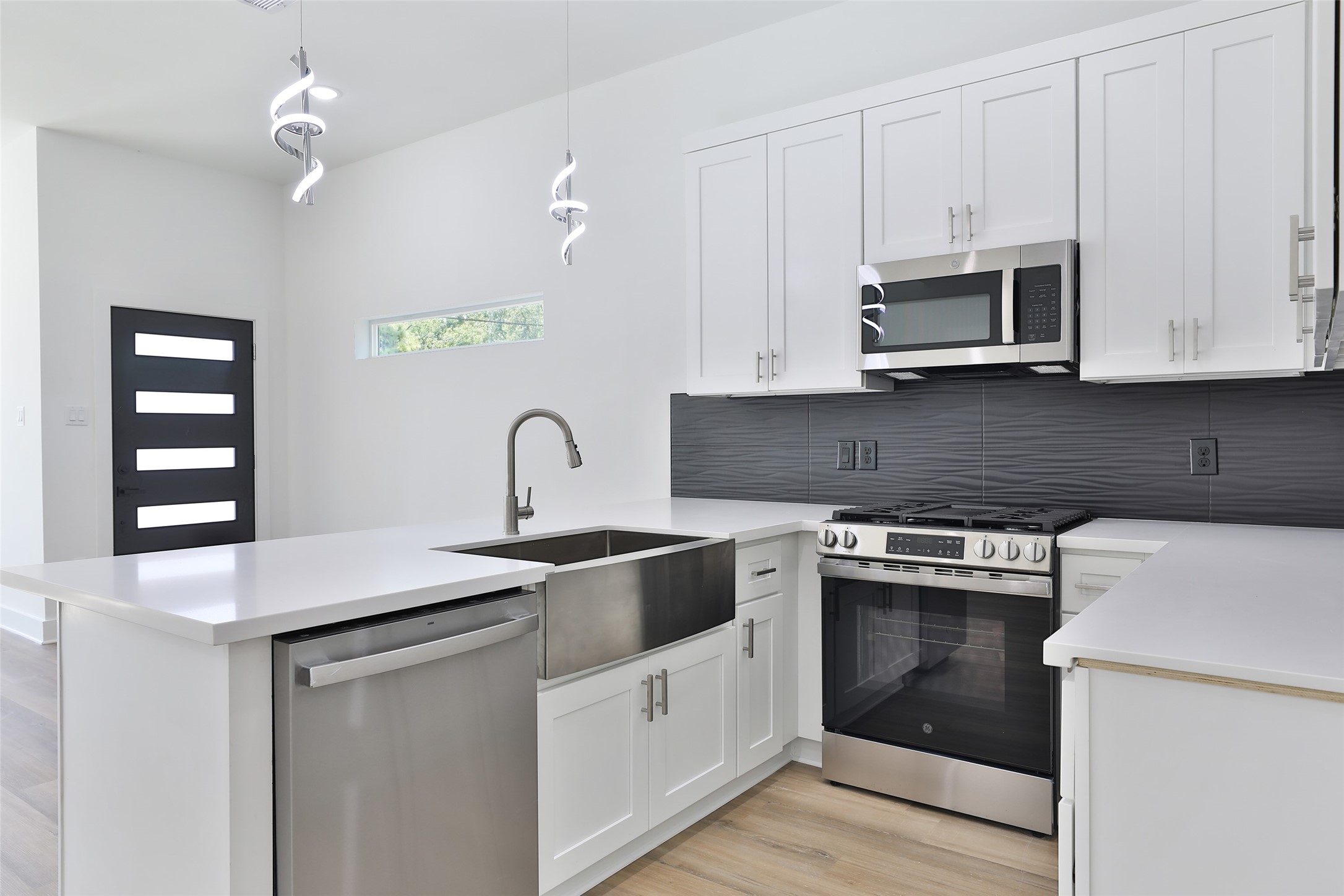 8109 Cabot Street, Unit A/B Houston, TX 77078 - Photo 13 of 33 a kitchen with stainless steel appliances granite countertop white cabinets a sink and dishwasher