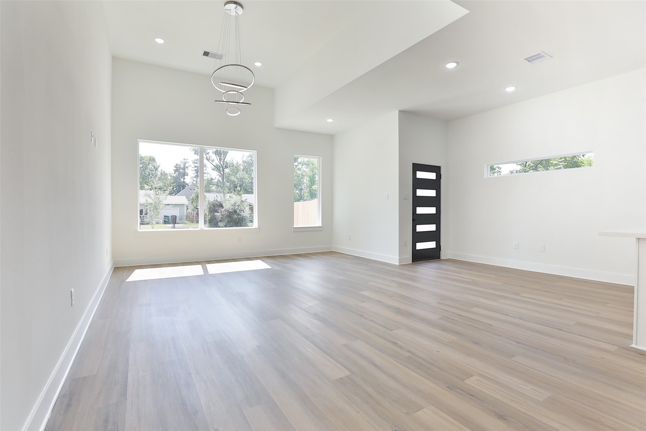 8109 Cabot Street, Unit A/B Houston, TX 77078 - Photo 9 of 33 an empty room with wooden floor cabinet and windows