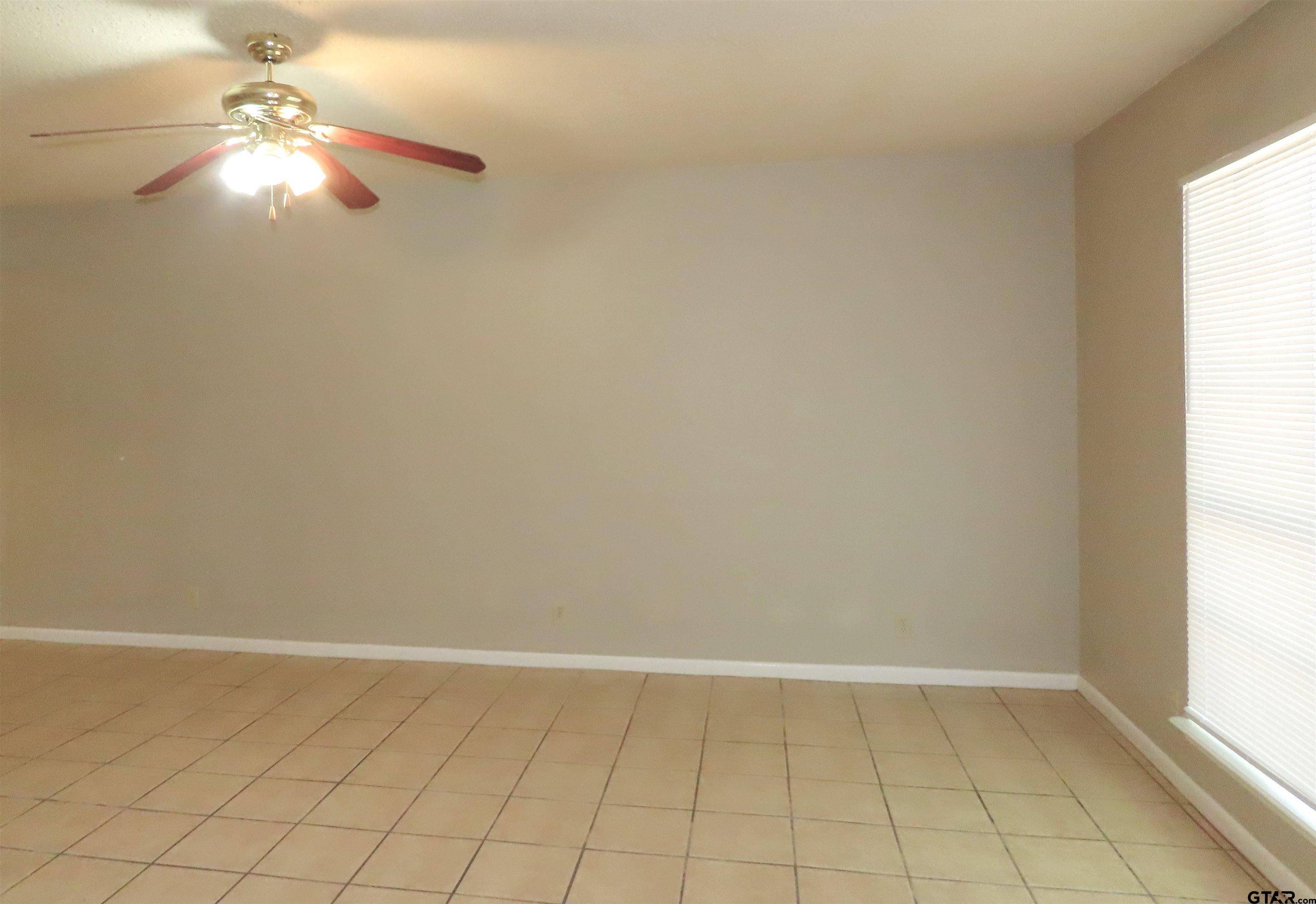 402 Muller Garden Road Tyler, TX 75703 - Photo 9 of 33 en empty room with fan and window