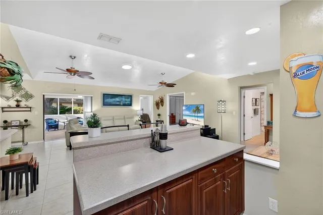 a kitchen with counter top space and living room view