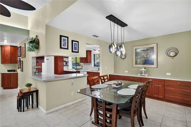 a view of a dining room with furniture and chandelier