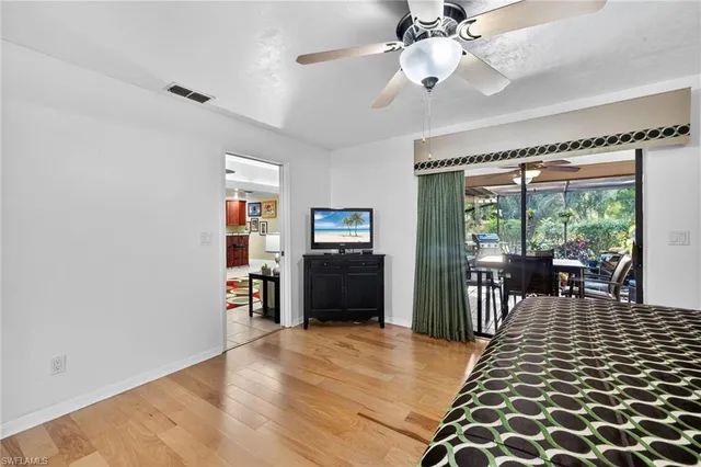 a view of a livingroom with furniture window and wooden floor