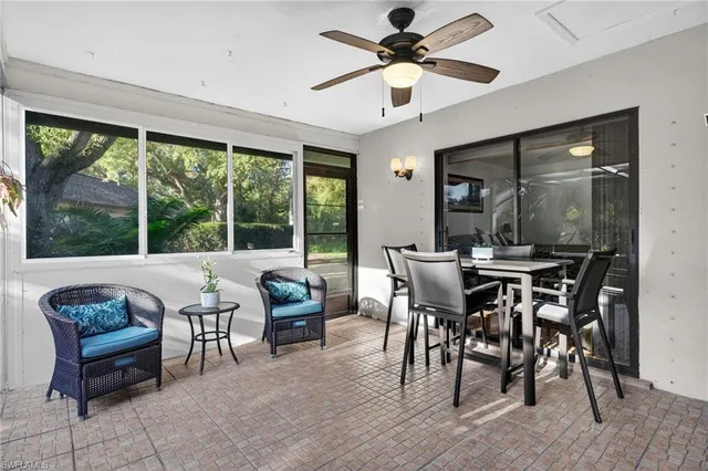 a dining room with furniture window and wooden floor
