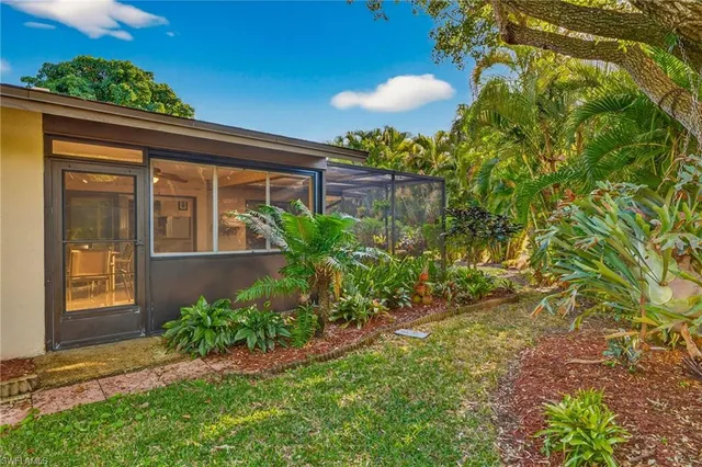 a swimming pool with outdoor seating and plants