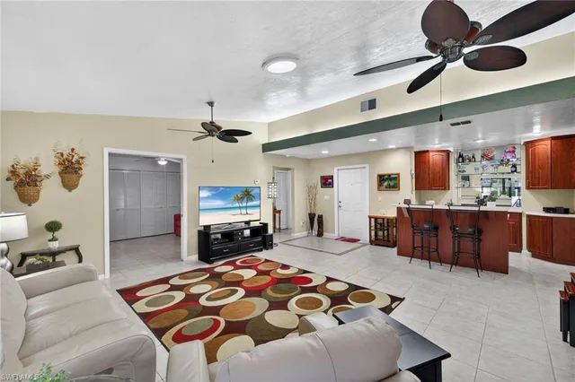 a living room with furniture ceiling fan and a rug