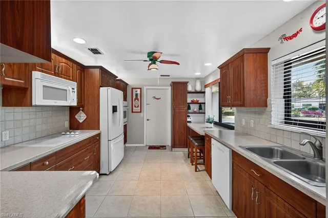 a kitchen with stainless steel appliances granite countertop a sink and a stove
