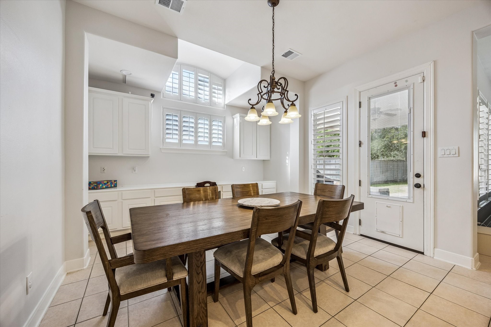 3047 Bonnebridge Way Boulevard Houston, TX 77082 - Photo 18 of 50 This breakfast area features a convenient built-in buffet with ample cabinet storage and serves as an ideal workspace. Presents an abundance of natural light and direct access to the covered veranda and backyard.