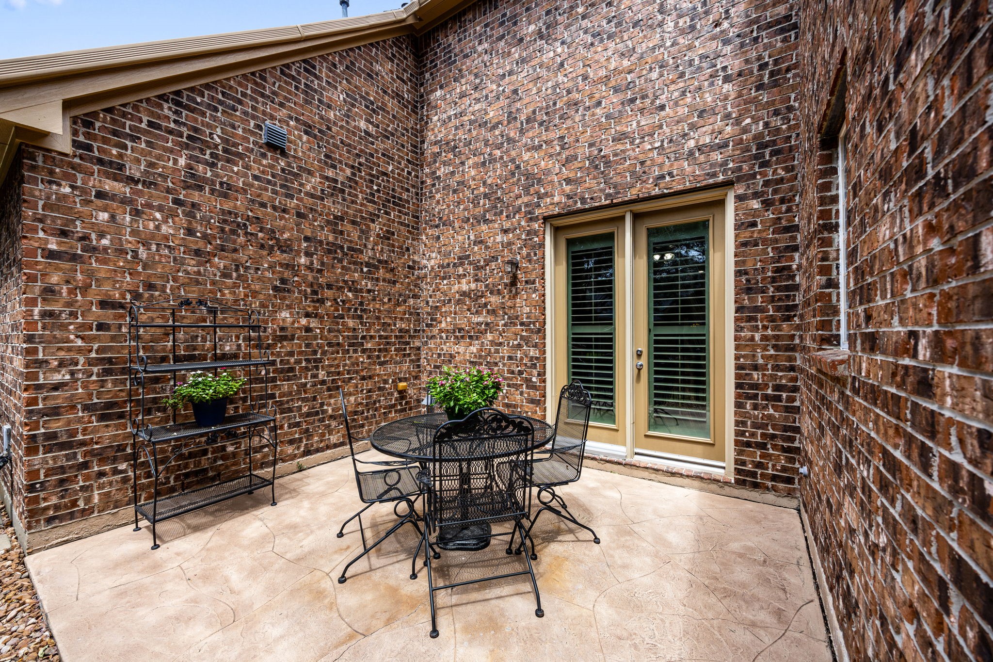 27642 Linden Ridge Lane Fulshear, TX 77441 - Photo 27 of 42 This quaint side Patio is located just outside the Home Office and is accessed through double French doors. It offers a private outdoor retreat, perfect for enjoying a quiet morning coffee, taking a break during the day, or simply relaxing in a peaceful setting.