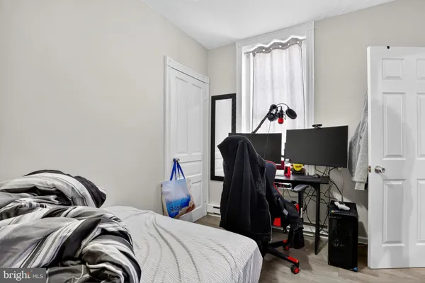 a bed room with a bed and a television