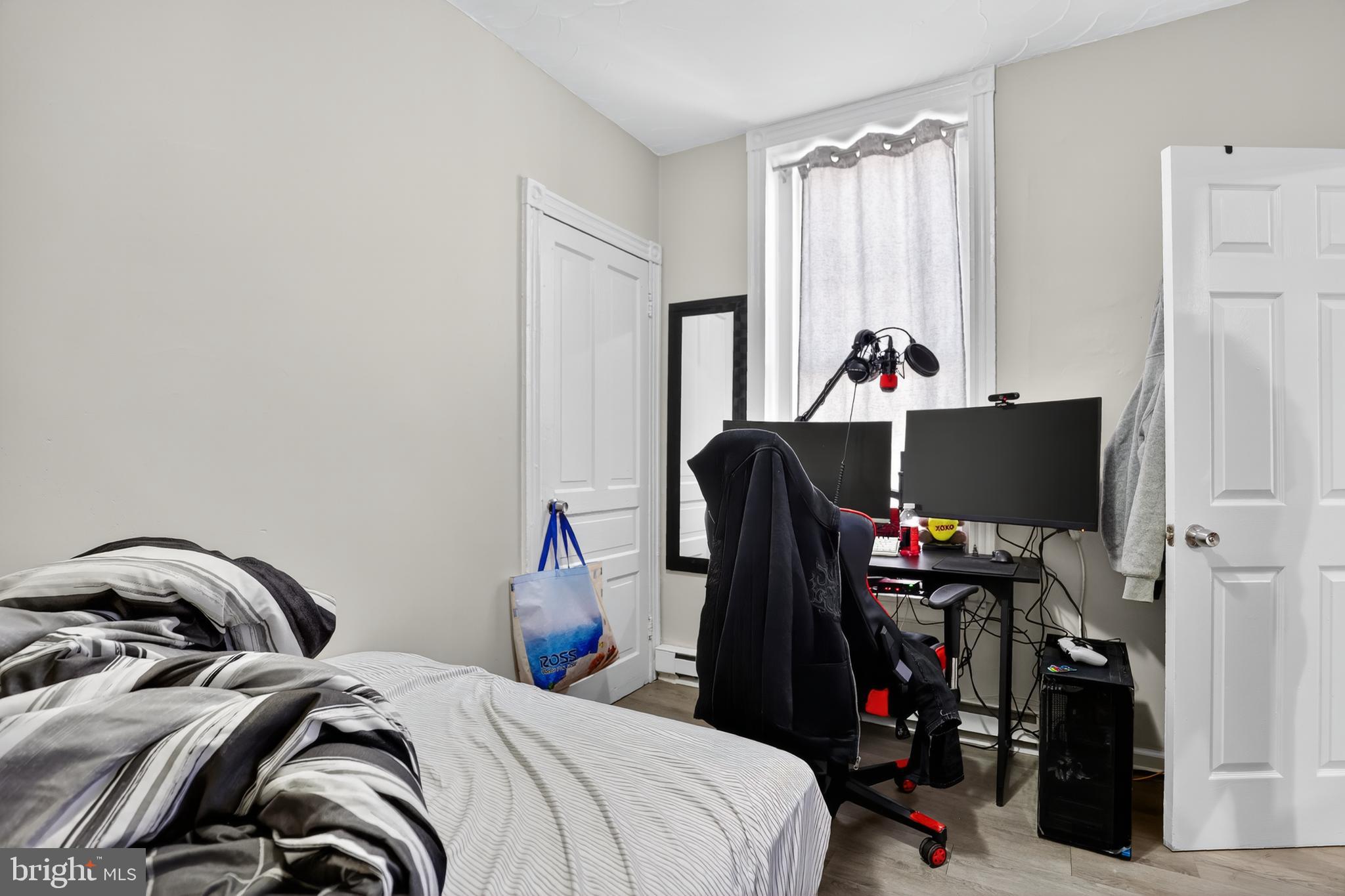 1259 North 10th Street Reading, PA 19604 - Photo 13 of 36 a bed room with a bed and a television