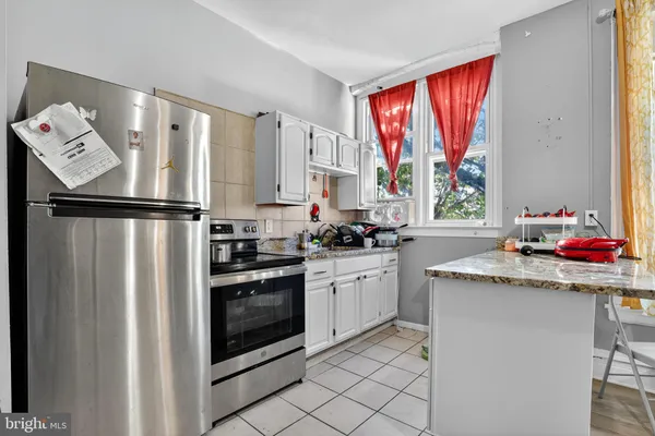 a kitchen with stainless steel appliances granite countertop a refrigerator sink and stove