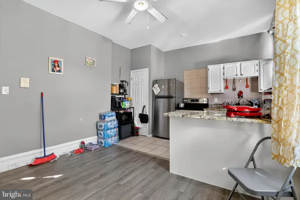 a kitchen with refrigerator cabinets and window