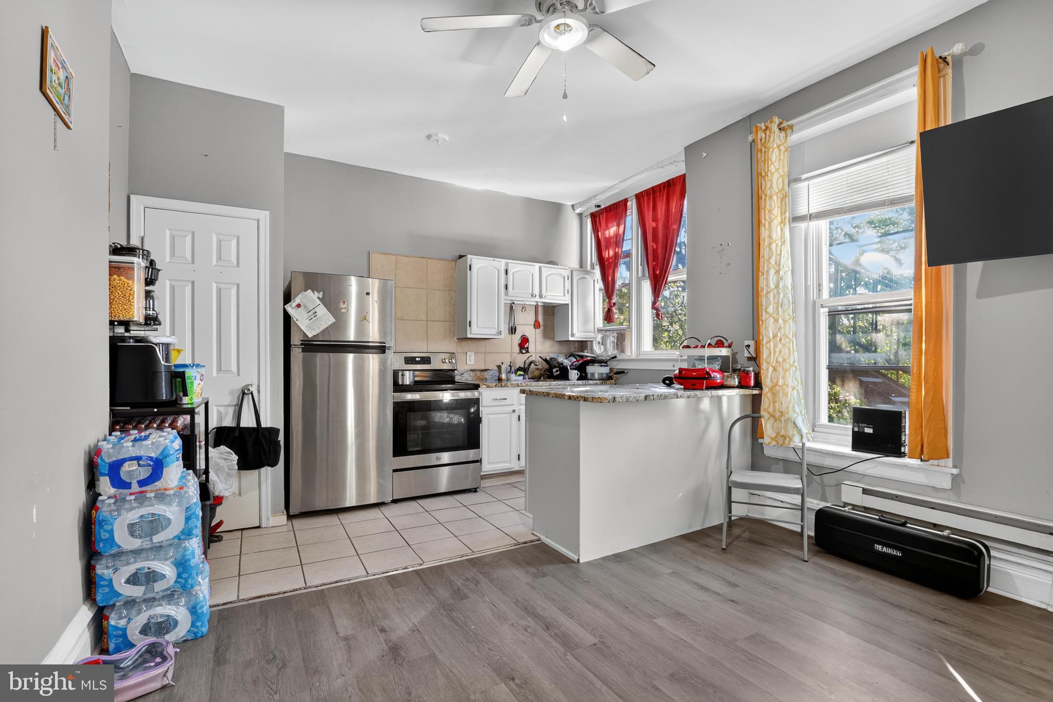 1259 North 10th Street Reading, PA 19604 - Photo 18 of 36 a kitchen with refrigerator cabinets and window