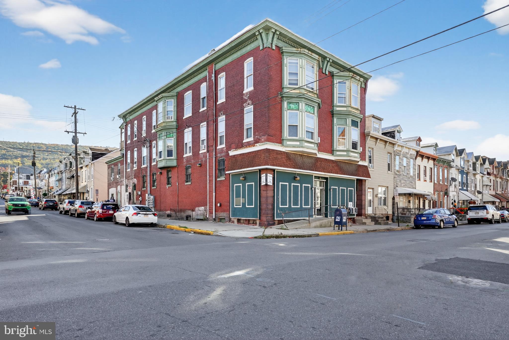 1259 North 10th Street Reading, PA 19604 - Photo 2 of 36 a city street lined with parked cars and buildings