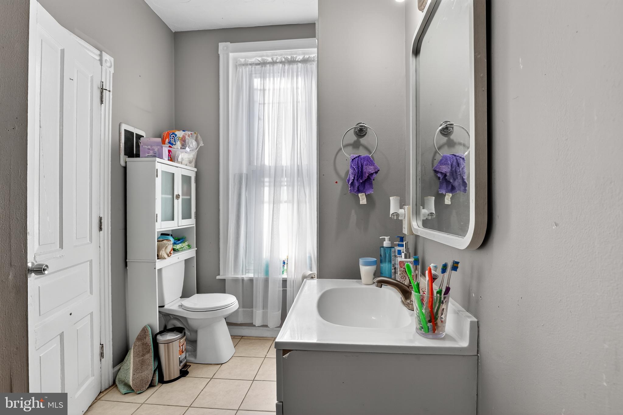 1259 North 10th Street Reading, PA 19604 - Photo 23 of 36 a bathroom with a sink toilet and shower